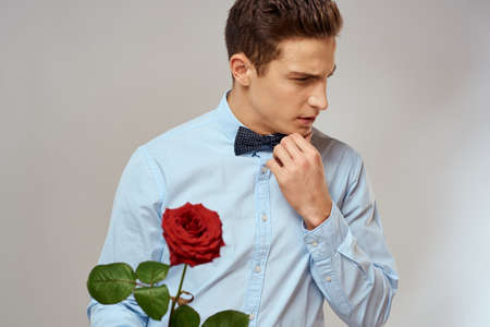 romantic man with red rose and light shirt pants suit