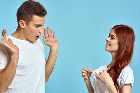 Young woman and man stinks relationship on blue background cropped view of couple in loveの写真素材