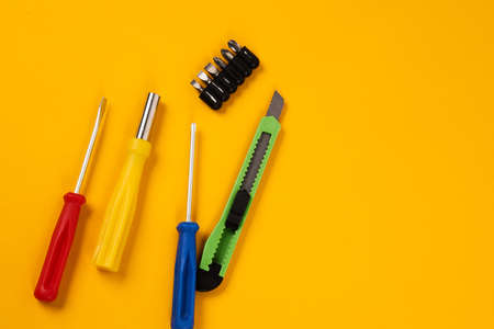 screwdrivers and construction tools on yellow background equipment for repair industry