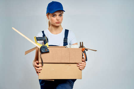 Working woman box with tools courier delivery workの写真素材