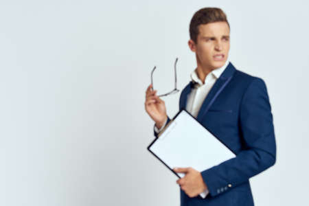 Businesswoman in suit glasses holding office documents self-confidenceの写真素材