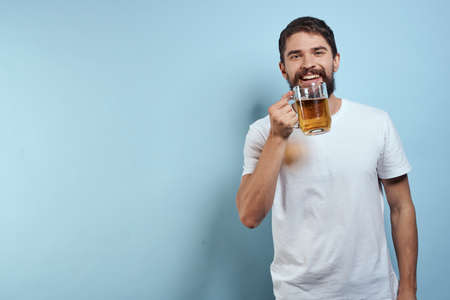 Drunk man beer mug fun white t-shirt lifestyle blue backgroundの写真素材