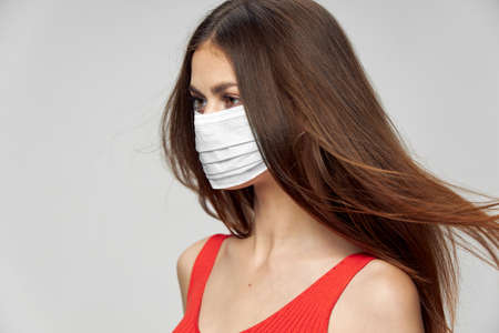Woman in medical mask white t-shirt side viewの写真素材