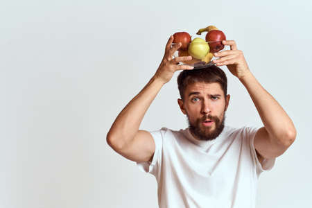 man with fresh fruit in a glass cup gesturing with hands vitamins health energy model bushy beard...