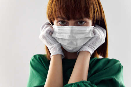 Woman in fashion dress posing in medical mask virus covid-19の写真素材