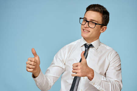 Business man white shirt tie glasses self-confidence official blue backgroundの写真素材