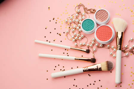 eyeshadow accessories beads makeup brushes collection professional cosmetics on pink backgroundの写真素材