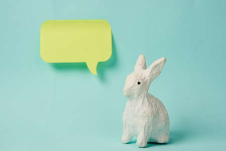Easter bunny with a label for the inscription on a light background sticker Copy Space