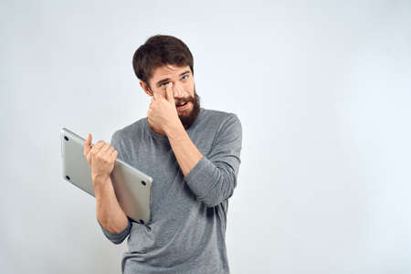 Man with laptop in hands technology internet self-confidence light backgroundの写真素材