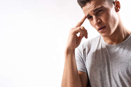 sporty man in white t-shirt on a light background gesturing with his hands cropped view Copy Spaceの写真素材