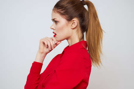 portrait of a woman with red lips in a shirt on a light background cropped view model makeup hairstyleの写真素材
