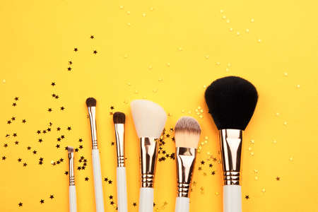 makeup brushes of different sizes on yellow background cropped view Copy Spaceの写真素材