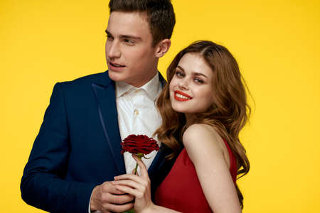 Couple in love man and woman with red rose classic costume red dress modelの写真素材