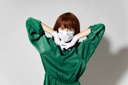 Fashion female coronavirus, model posing with gloves and protective medical maskの写真素材