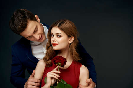 Beautiful couple charm hug lifestyle relationship rose luxury dark backgroundの写真素材