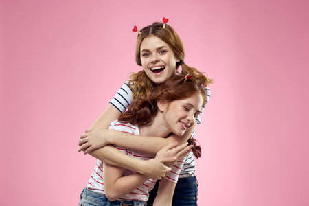 Cheerful mom and daughter joy lifestyle studio pink background familyの写真素材