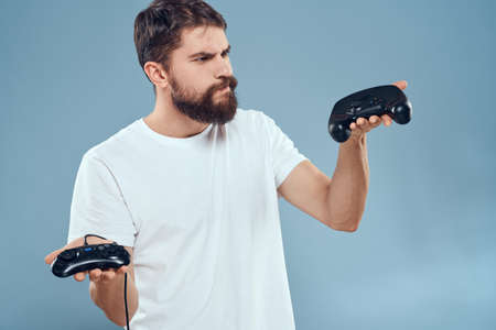 Cheerful man with joysticks in hands lifestyle leisure blue background