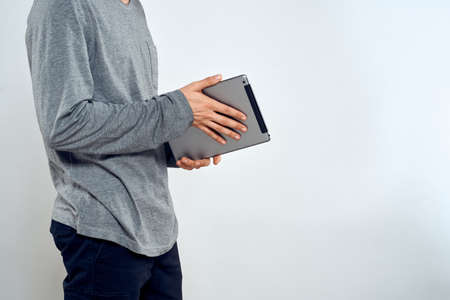 Man with tablet in hands technology lifestyle internet communication work light background cropped...