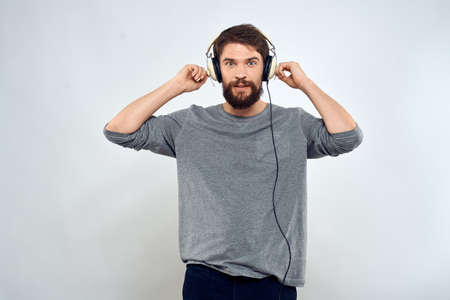 Man in headphones listens to music lifestyle leisure light backgroundの写真素材