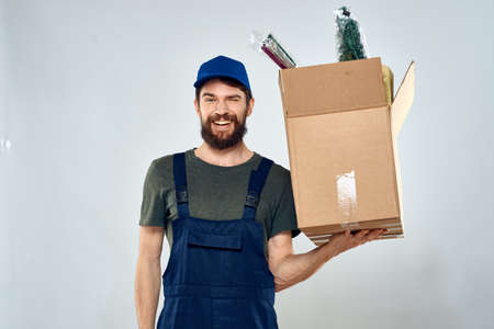 Male worker loading delivery boxes in hands packing lifestyle