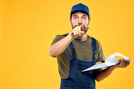 Man in working form documents transportation delivery service yellow background