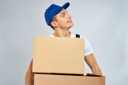 working man in uniform with boxes in his hands delivery loader lifestyleの写真素材