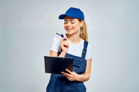 Working woman in uniform courier delivery service documentsの写真素材