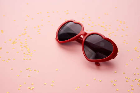 glasses with red frames on a pink backgroundの写真素材