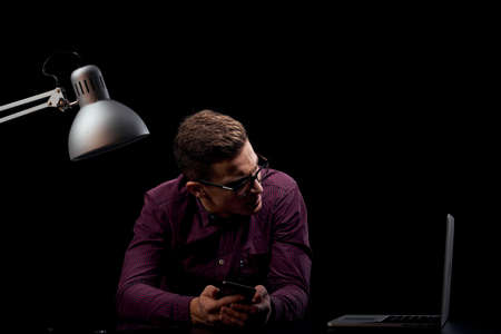 Male manager indoors dark background communication red shirt model glasses new technologies business financeの写真素材