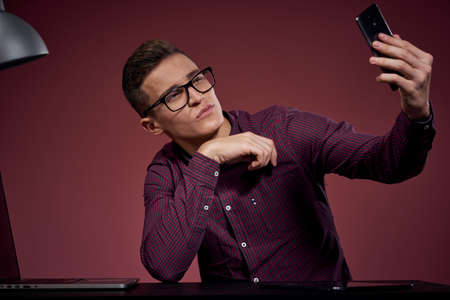 Business man in office and talking on the phone manager red background model cropped view of laptop...