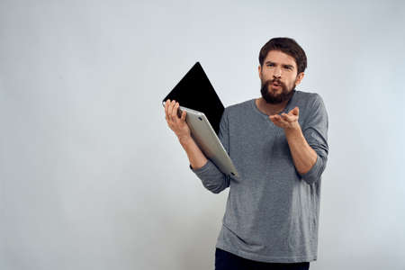 man holding laptop technology internet work communication light backgroundの写真素材