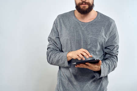 Man with tablet in hands technology internet lifestyle confident cropped view