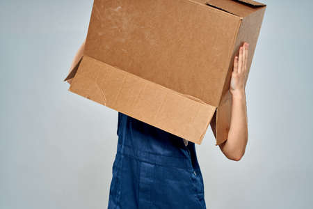 Woman in working uniform box packing service lifestyleの写真素材