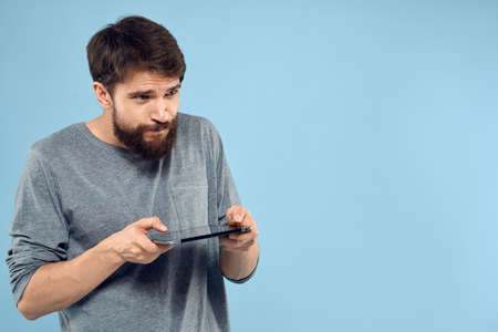 Man with tablet in hands technology lifestyle wireless device blue backgroundの写真素材