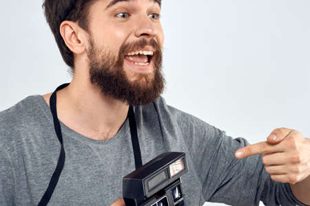 male photographer holding camera professional lens creative studio work light backgroundの写真素材