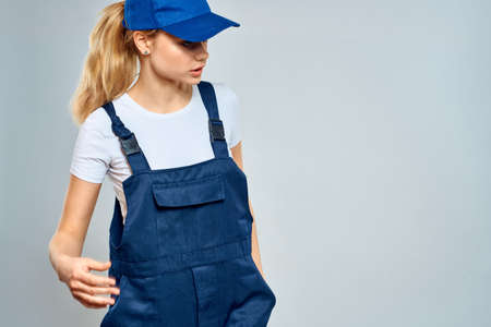 Woman in working uniform blue cap service lifestyle serviceの写真素材