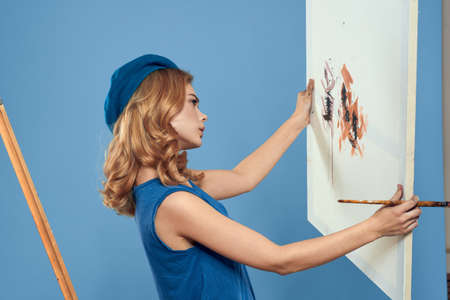 Woman artist tail hand brush drawing art Creative lifestyle blue background