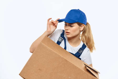 Woman working uniform box in hands packing service light background