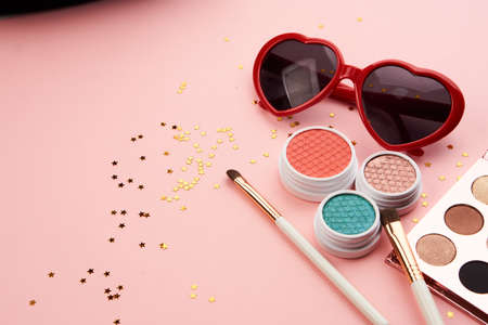 eyeshadow accessories beads makeup brushes collection professional cosmetics on pink backgroundの写真素材