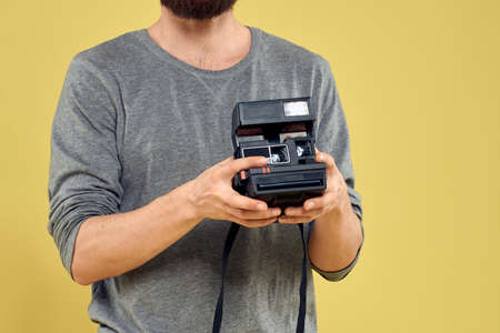 Photo camera in the hands of a man professional equipment hobby Creative approach studio cropped...