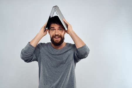 Emotional man holding a laptop success modern style work light background