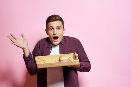 Man with wooden pallet fast food diet food lifestyle pink background