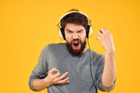 Man with headphones music lifestyle lifestyle technology yellow background