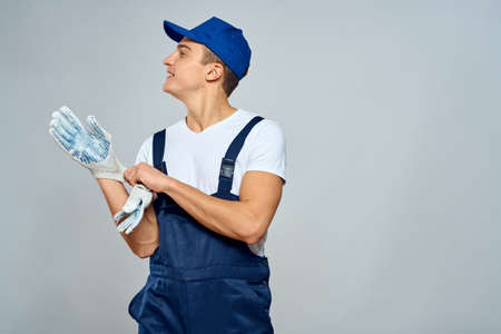 working man in uniform service lifestyle delivery service light background