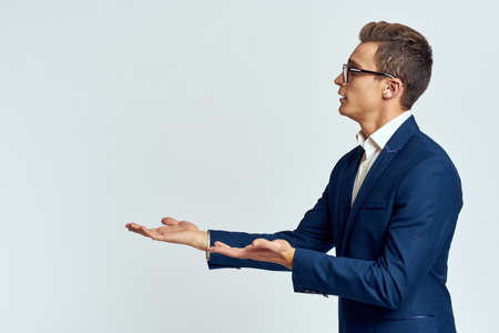 Business man in a suit of self-confidence official and recognizes a light backgroundの写真素材