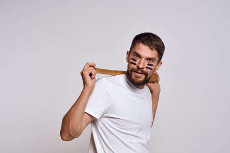 Energetic man holding a bat behind his head and emotions light background baseball sportの写真素材