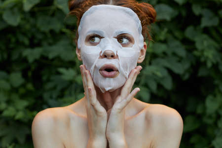 Portrait of a girl face mask Touch your face with your hands clear skinの写真素材