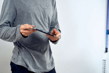 Man with tablet in hands technology lifestyle internet communication work light background cropped viewの写真素材