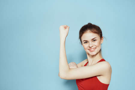 Sportive woman red tank top workout lifestyle gym blue backgroundの写真素材