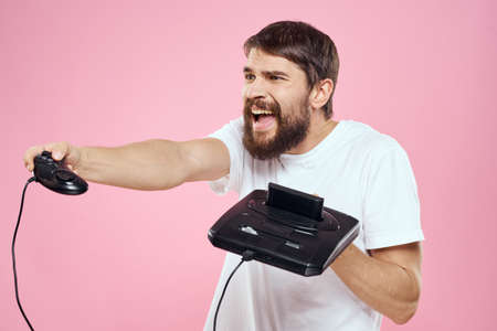 Man with prefix in hand joystick games lifestyle fun pink background white t-shirt